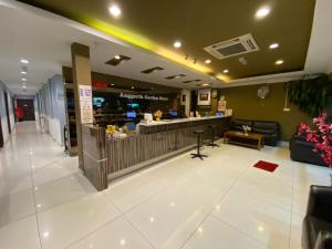 a lobby with a waiting area and a restaurant at Anggerik Garden Hotel - AG Hotel in Sitiawan