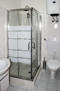 a bathroom with a shower with a toilet and a sink at Appartamento Mare Marconi in Letojanni