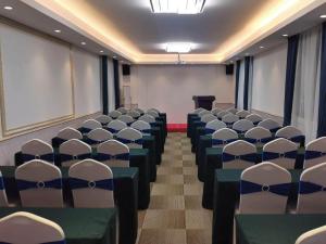 a conference room with chairs and a podium at Kyriad Marvelous Hotel Suzhou Guanqian Street and Shiquan Street in Suzhou