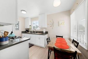 a kitchen with a table with an orange plate on it at Cozy and Bright Centrally Located NEW 2BR Property! in Inglewood