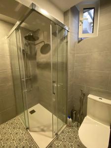 a shower stall in a bathroom with a toilet at Beautiful apartment 1 minute walk to the beach in Puerto de Sagunto