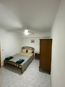 a bedroom with a bed and a ceiling at Beautiful apartment 1 minute walk to the beach in Puerto de Sagunto