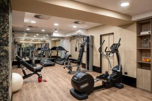 a gym with treadmills ellipticals and tread machines at UNAHOTELS Galles Milano in Milan