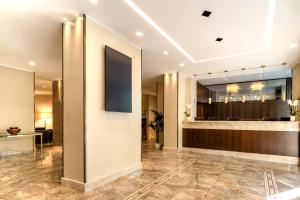 a lobby of a hotel with a reception desk at UNAHOTELS Galles Milano in Milan