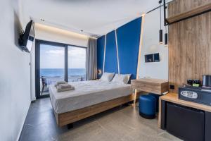 a bedroom with a bed and a view of the ocean at Island Sea Side Hotel - Adults Only in Rhodes Town