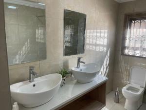 a bathroom with a sink and a toilet at Mo'Acress Lifestyle in Temba +19 photos
