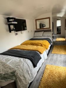 two beds in a room with two rugs at Quay Central in Exeter