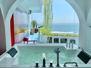 a bathroom with a sink with a view of the ocean at Morabito Art Cliff in Uluwatu