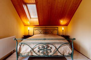 a bedroom with a bed with a wooden ceiling at Luxusní horská chata Boží Dar in Boží Dar