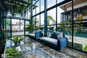 a lobby with two blue couches and a pool at Blue Lagoon Hotel in Chiang Rai