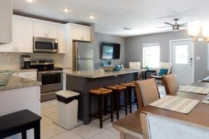 a kitchen with a large island with bar stools at Miami Beach Villa with Sparkling Pool! Sleeps 10+! in North Miami Beach