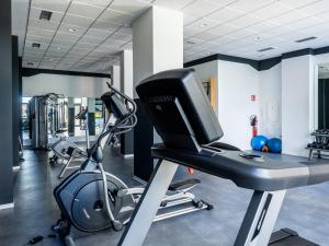 a gym with a computer on a treadmill at Apartment Abora with Pool, Gym and Free Parking in Las Palmas de Gran Canaria