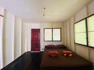 a bedroom with a bed and a red door at Banana Resort in Ko Phayam