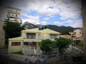 a building with a mountain in the background at Centrally Apartment - Xanthi in Xanthi