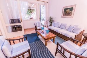 a living room with couches and chairs and a table at Liguria Garden in Olbia