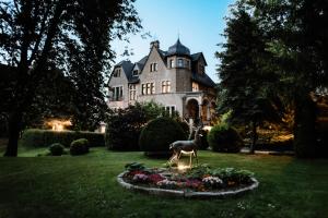 une statue de cerf devant une maison dans l'établissement Schlosshotel Stecklenberg, à Thale