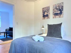 a bedroom with a blue bed with two towels on it at Two Bedroom Apartment In Copenhagen, Brohusgade 16, in Copenhagen