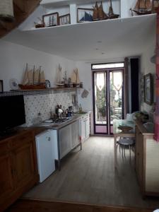 a kitchen with a sink and a stove top oven at le corps de garde du Crotoy in Le Crotoy