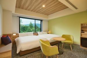 Ein Bett oder Betten in einem Zimmer der Unterkunft Hakone Kowakien Hotel
