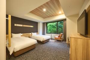 Ein Bett oder Betten in einem Zimmer der Unterkunft Hakone Kowakien Hotel