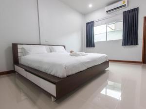ein Schlafzimmer mit einem großen Bett in einem Zimmer in der Unterkunft Tonsoi Hathairat in Ban Tao Pun
