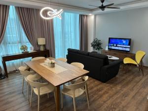 a living room with a table and a couch at Home Abroad 1 Jazz Suites Vivacity in Kuching