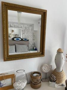 a mirror on a wall with a bed in a room at Luxury sea-apartment in Skala Fourkas in Skála Foúrkas