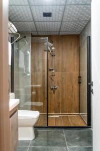 a shower with a glass door in a bathroom at GRAND MOON HOTEL in Esenyurt