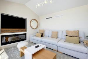 a living room with a couch and a flat screen tv at Villa Endless Summer in Estepona