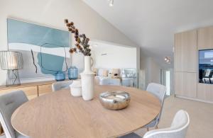 a dining room with a table with vases and chairs at Villa Endless Summer in Estepona