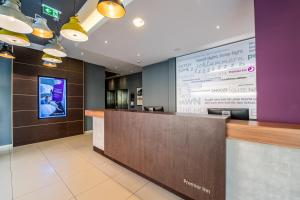 a lobby with a reception desk and a large screen at Premier Inn Nürnberg City Centre in Nürnberg