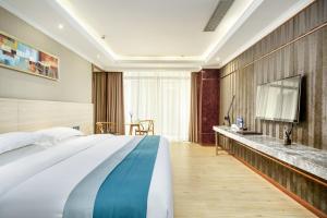 a bedroom with a large bed and a sink at Zhongtian Mayfair Hotel - Bao'an International Airport Xixiang Subway Station in Shenzhen