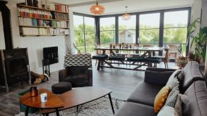 a living room with a couch and a table at Oasis de tranquiillité in Quend