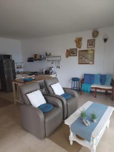 a living room with two couches and a table at Shabby chic beach cottage Hvar in Hvar