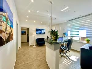 an office with a desk and chairs in a room at Marea B&B in Milazzo