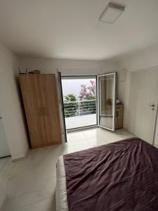 a bedroom with a bed and a large window at Apartmani Ema in Sutomore