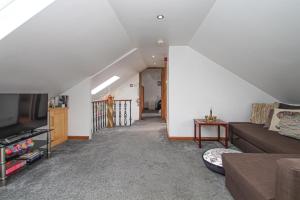 a living room with a couch and a tv at The Marrakech Style Loft Apartment in Carstairs