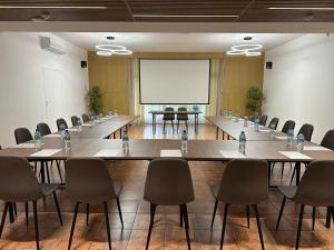 a conference room with tables and chairs and a whiteboard at Centrum Konferencyjno-Apartamentowe Mrówka in Warsaw