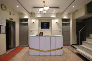 a lobby with a white counter in a building at Amrit Hotel in New Delhi