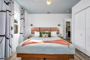 um quarto com uma cama grande e paredes brancas em Goodtime House 5 min to Beach, Pool Coming Sept! em Delray Beach