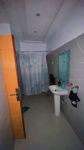 a bathroom with a sink and a shower curtain at Riad dar salam in Agadir