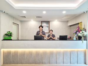 two women sitting at a counter in a waiting room at Citin Pratunam Bangkok by Compass Hospitality in Bangkok