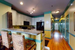 a kitchen with a large island in a room at Pavilion Watch #2E in Folly Beach