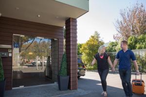 a man and a woman walking out of a building at Boulcott Lodge in Lower Hutt