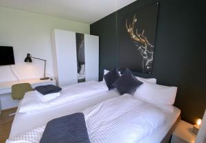 a bedroom with two beds and a painting on the wall at Ferienhaus Röns in Röns