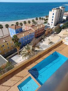 a view of a swimming pool and the beach at Seaview in Villajoyosa