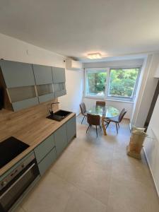 a kitchen with a counter and a table and chairs at New 1 bedroom near Center and beach in Split