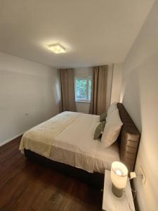 a bedroom with a large bed and a window at New 1 bedroom near Center and beach in Split