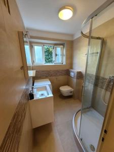 a bathroom with a shower and a sink and a toilet at New 1 bedroom near Center and beach in Split