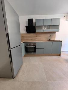 a kitchen with a refrigerator and a stove at New 1 bedroom near Center and beach in Split +5 photos